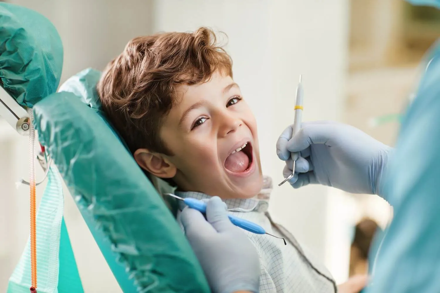 Smiling child receiving a dental examination